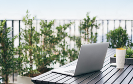 Laptop sitting on outdoor table