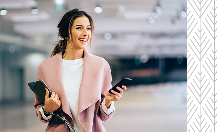 Smiling woman holding cell phone