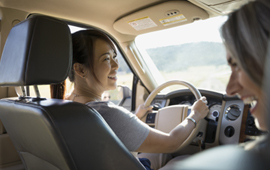 Woman driving and having conversation with passenger