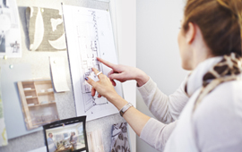 Woman pointing to floor plan